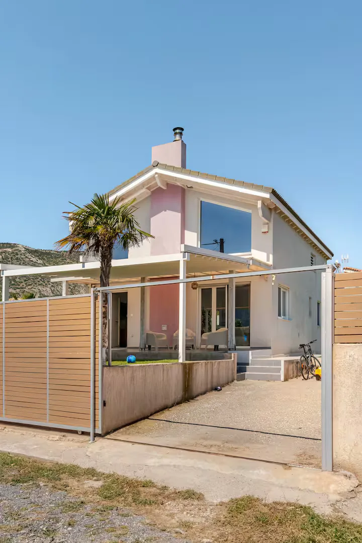 Coral-pink villa exterior at GS Vibes, Porto Rafti
